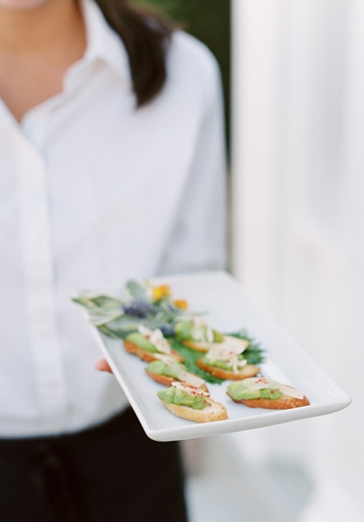 woman with crackers on a plate | Lisa Dupar Catering | Wedding & Event Catering in Seattle