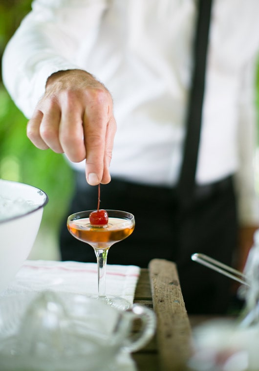 Waiter putting cherry on drink | Lisa Dupar Catering | Wedding & Event Catering in Seattle