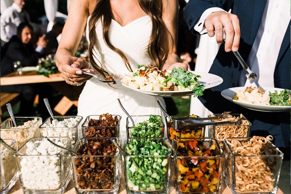 Bride and groom getting food | Lisa Dupar Catering | Wedding & Event Catering in Seattle